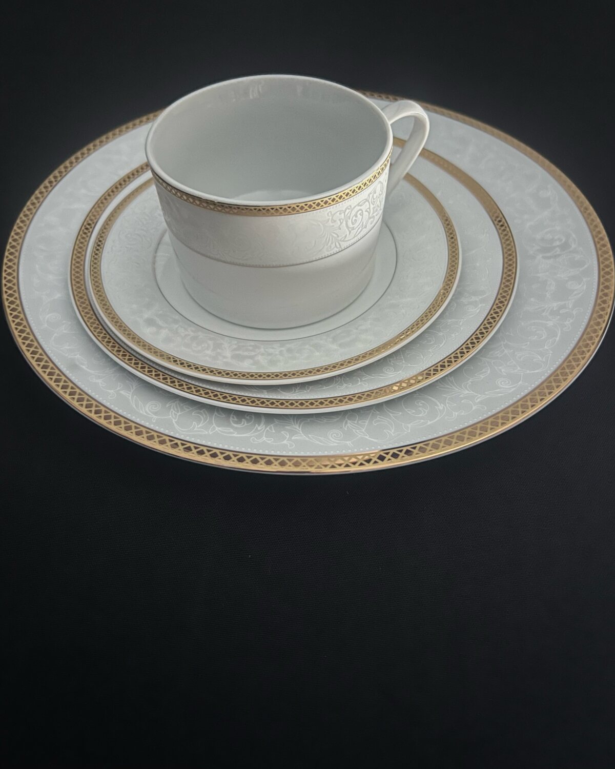 Pearl White place setting with gold lattice rim — cup, saucer and plates